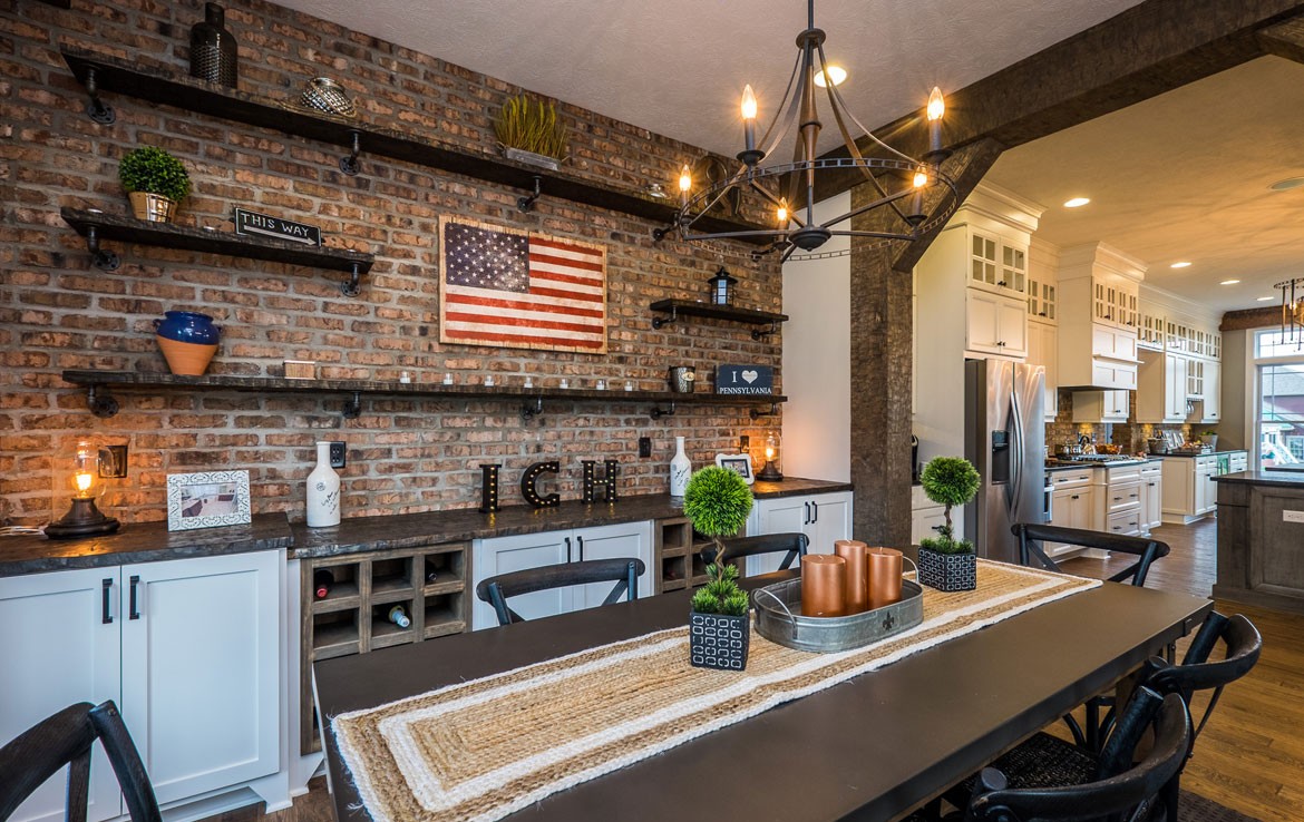 Napa luxury home dining room with brick wall – Infinity Custom Homes
