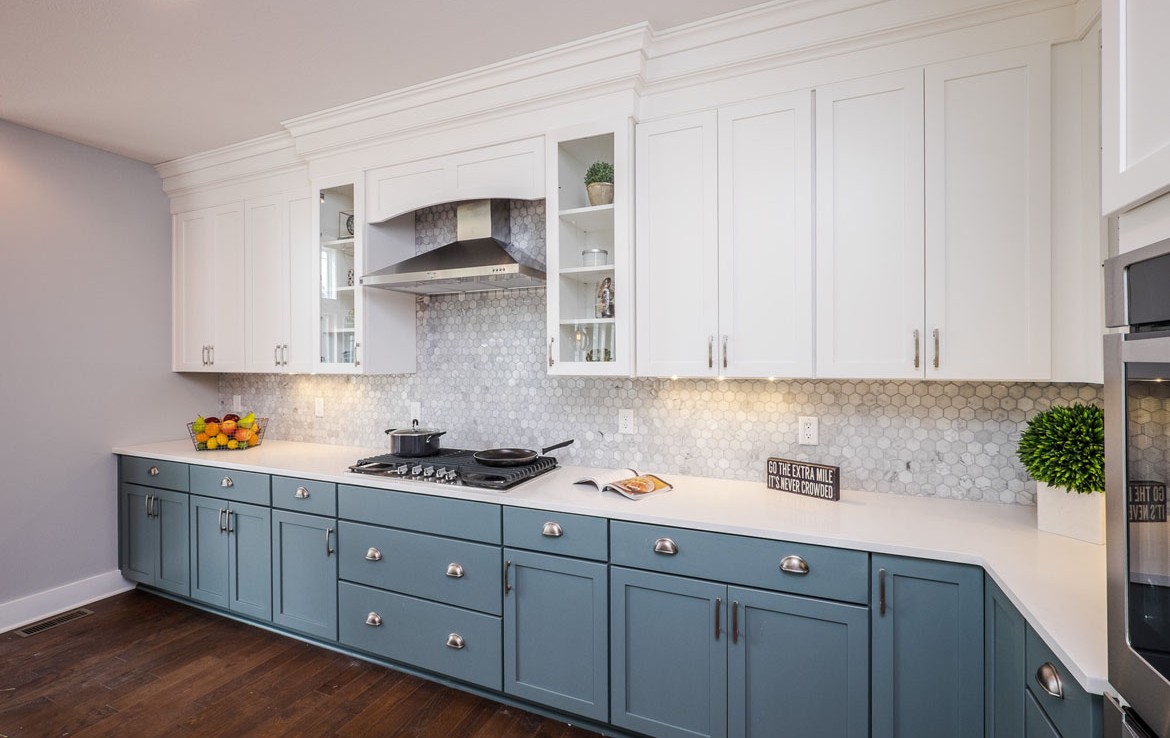 aspen luxury home kitchen white cabinets blue lower cabinets– Infinity Custom Homes