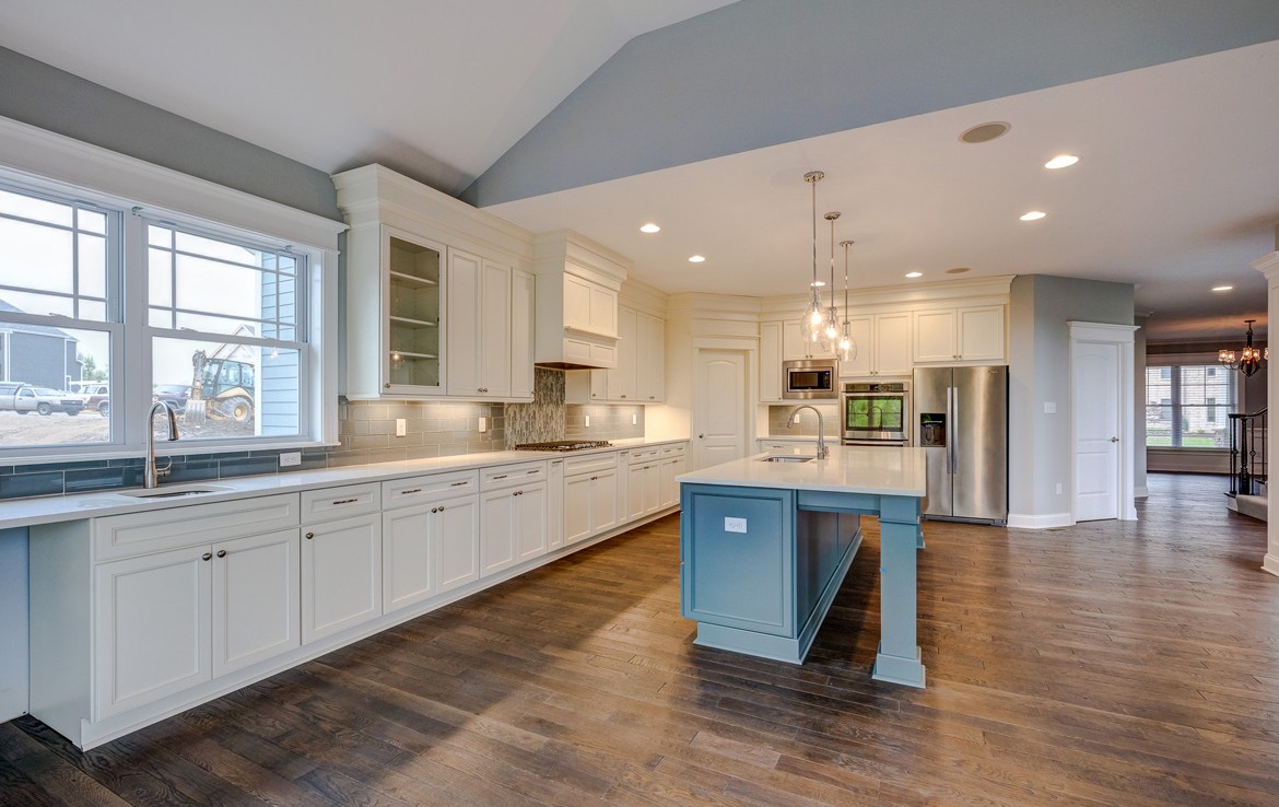 cambridge luxury home white kitchen cabinets, teal island, white countertop – Infinity Custom Homes