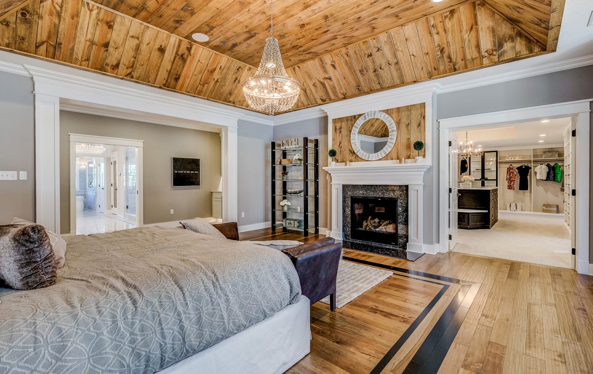 austin luxury home master suite with custom woodwork and fireplace – Infinity Custom Homes