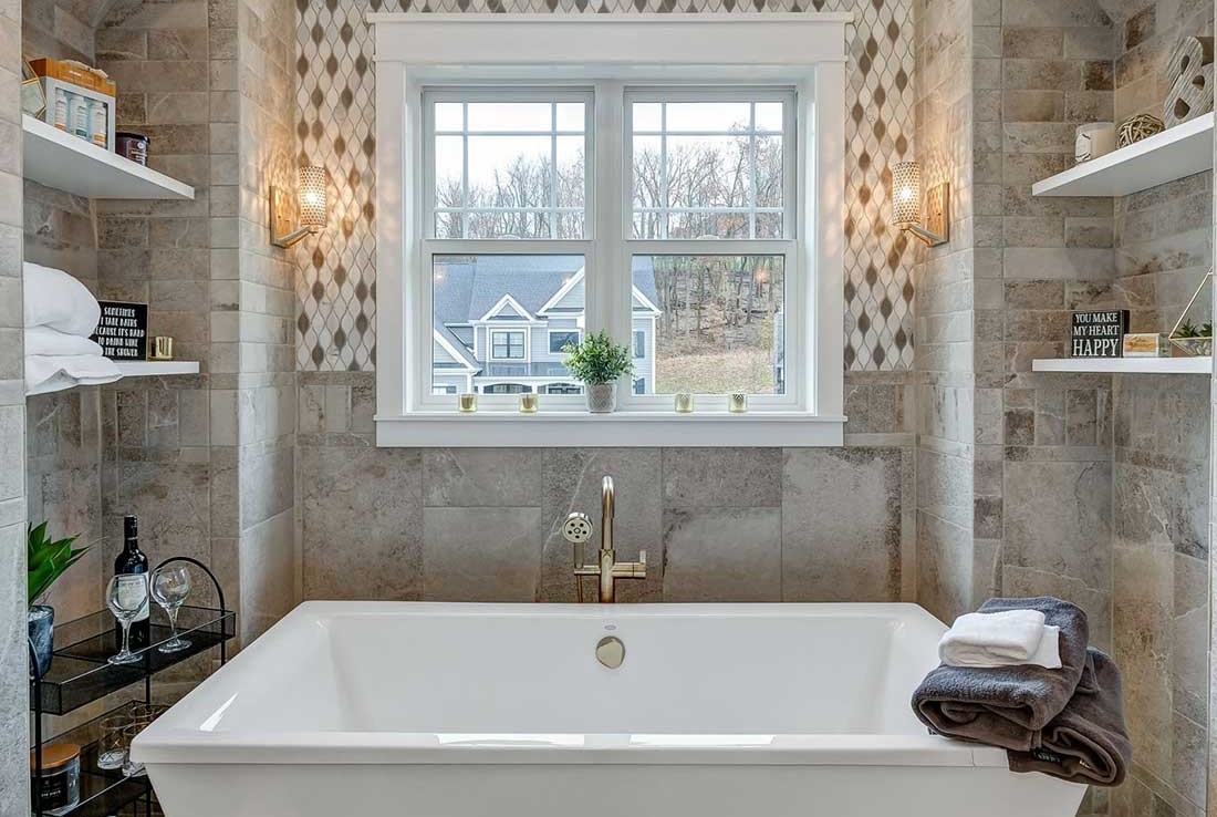 Tub, stone walls – Stone Shower – Austin Forest Edge Model Home