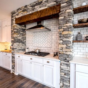 french country style kitchen with natural stone and subway tile