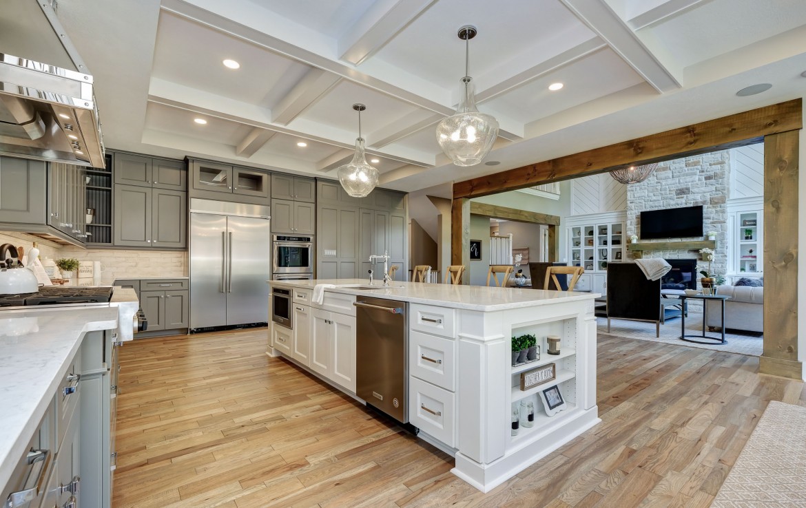 Nantucket Model Home, tudor style luxury home, farmstyle kitchen with gray cabinets and white island – Infinity Custom Homes