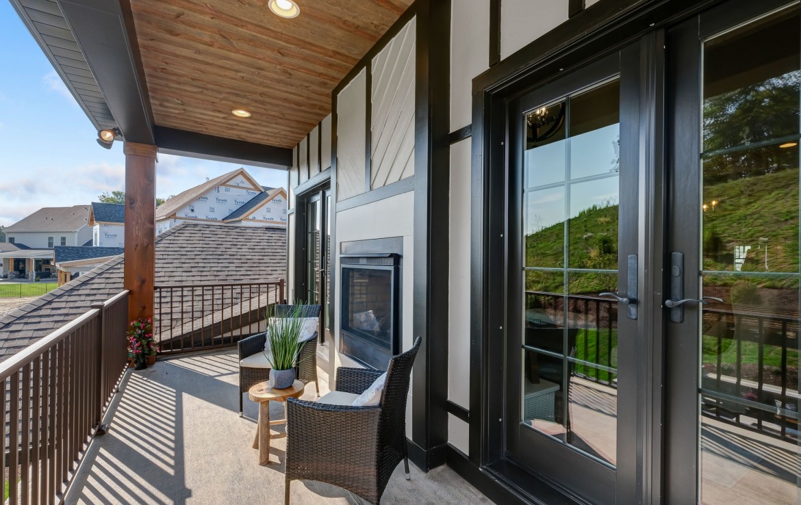 Nantucket Model Home, tudor style luxury home, master bedroom balcony with fireplace– Infinity Custom Homes