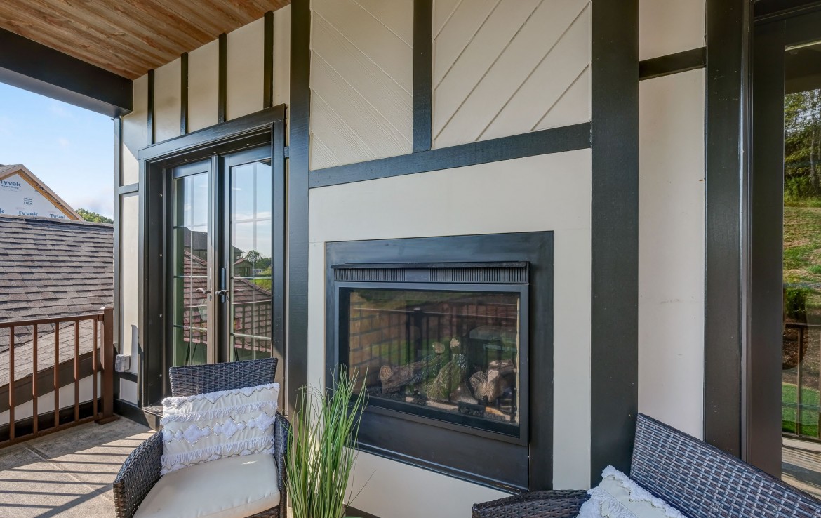 Nantucket Model Home, tudor style luxury home, master bedroom balcony with fireplace– Infinity Custom Homes