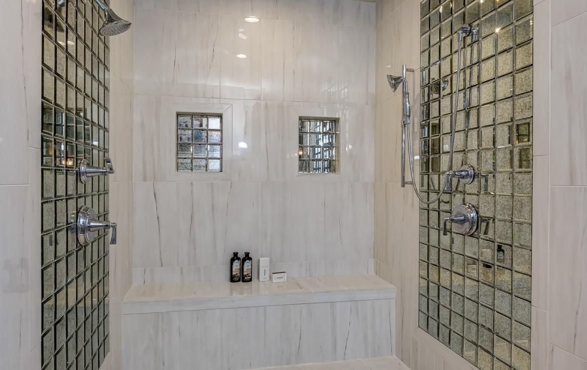 Nantucket Model Home, tudor style luxury home, master bathroom double shower with sitting – Infinity Custom Homes
