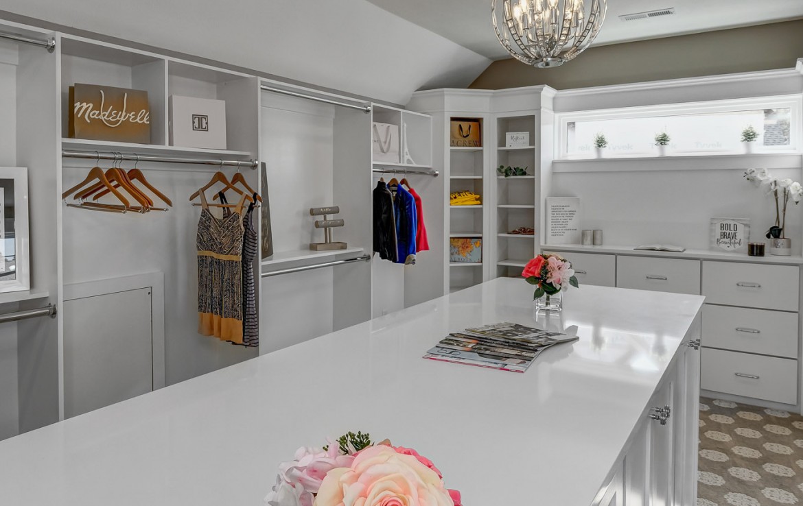 Nantucket Model Home, tudor style luxury home, master bedroom closet with folding island – Infinity Custom Homes