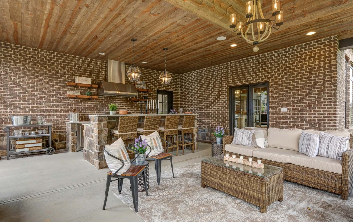 Nantucket Model Home, tudor style luxury home, exterior patio – Infinity Custom Homes
