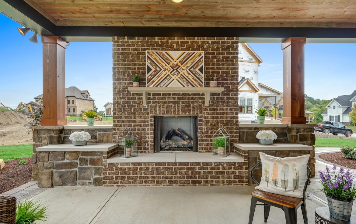 Nantucket Model Home, tudor style luxury home, exterior patio fireplace – Infinity Custom Homes