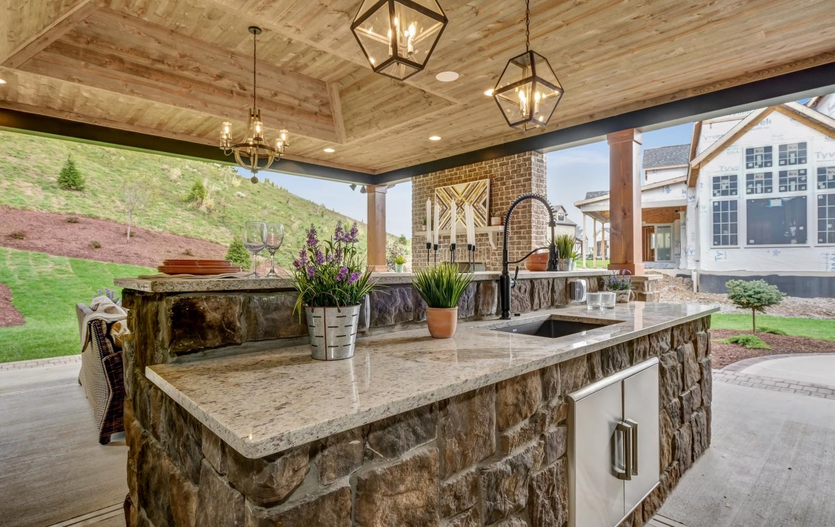 Nantucket Model Home, tudor style luxury home, exterior patio outdoor kitchen – Infinity Custom Homes