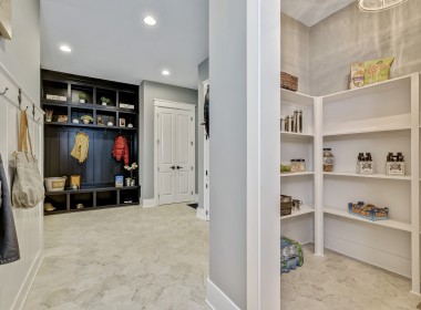 Portland Model Home, beach style luxury home in Mars PA, kitchen with dark blue cabinets with bronze hardware, pantry and mudroom – Infinity Custom Homes