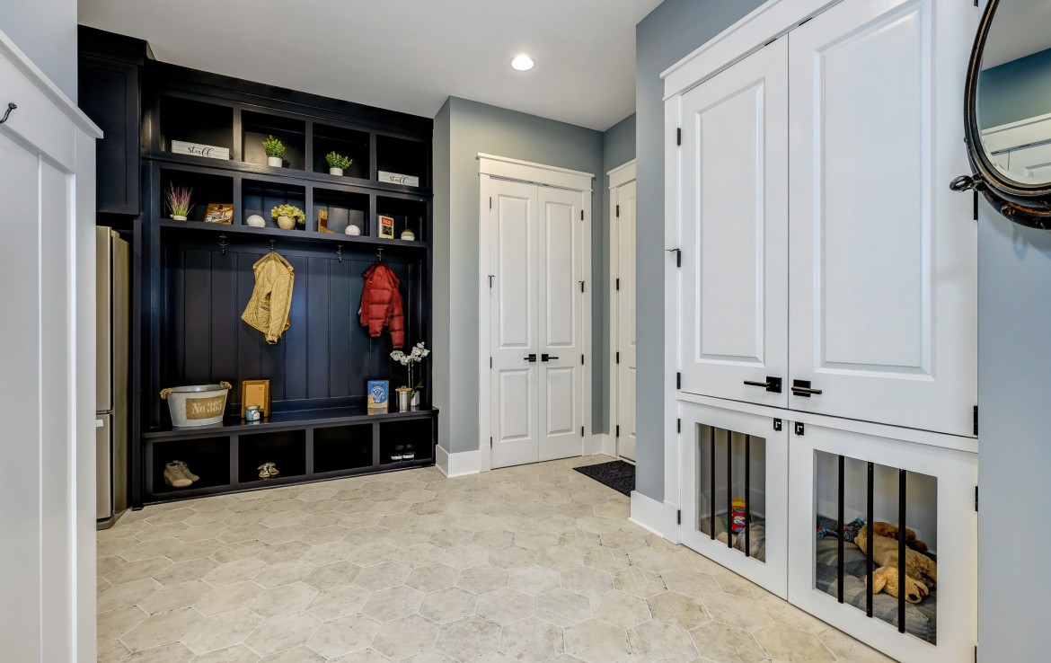 Portland Model Home, beach style luxury home in Mars PA, kitchen with dark blue cabinets with bronze hardware, pantry and mudroom – Infinity Custom Homes